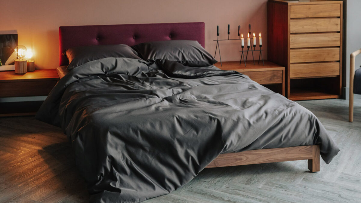 Draped luxury cotton bedding shown on our low upholstered Iona wooden bed