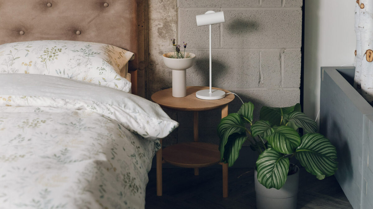 round oak side table with lower shelf here used as a bedside table