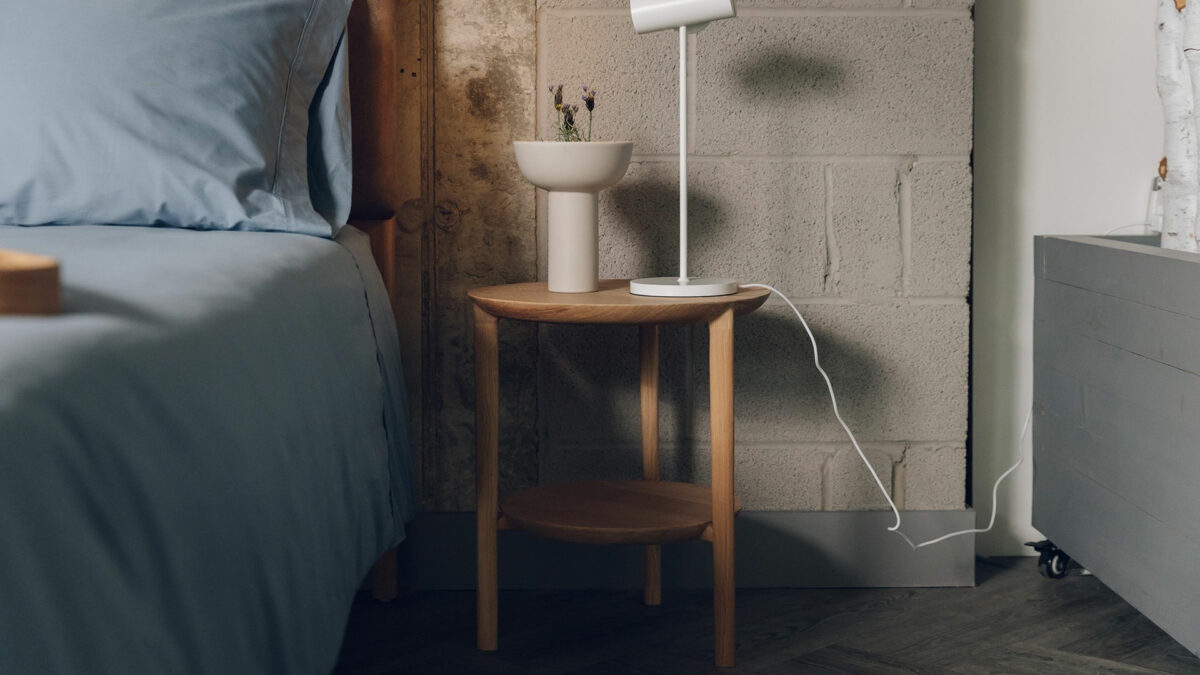 two tier side table in oak and used as a bedside table
