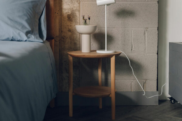 two tier side table in oak and used as a bedside table