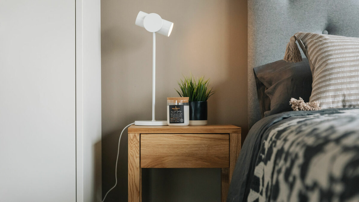 2 tier oak bedside table with white angled lamp