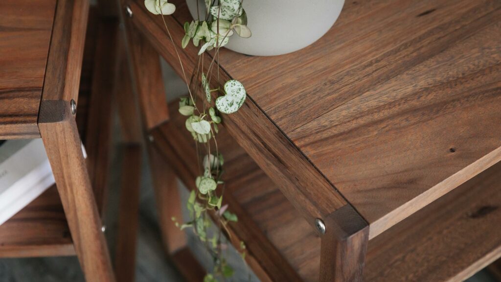 detail view of the dark wood bedside tables with open shelf