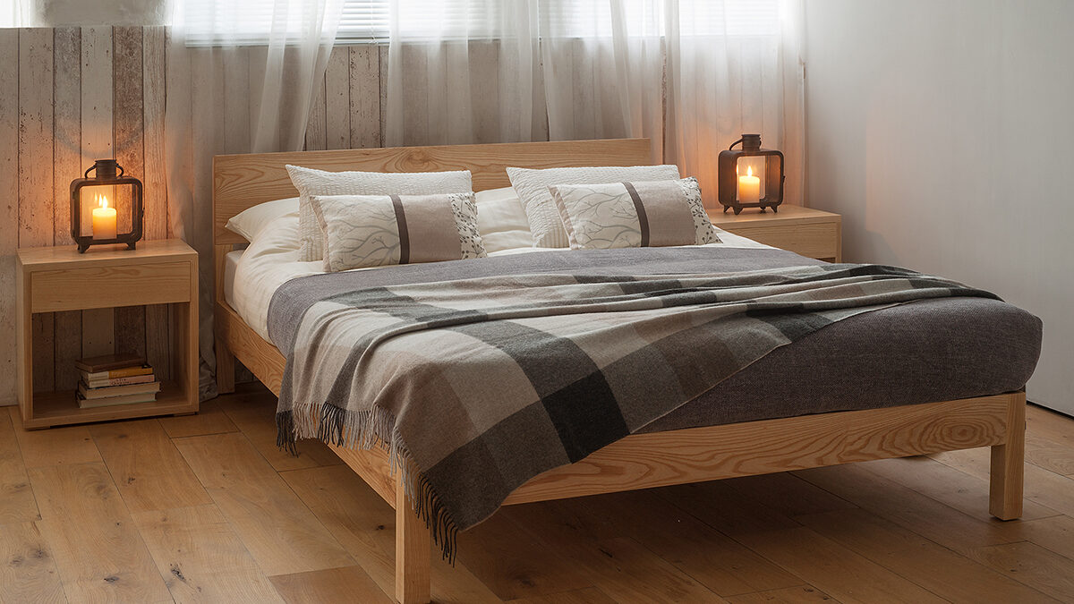 Sahara wooden Bed made from solid Ash is shown with Cube bedside tables in matching Ash wood.