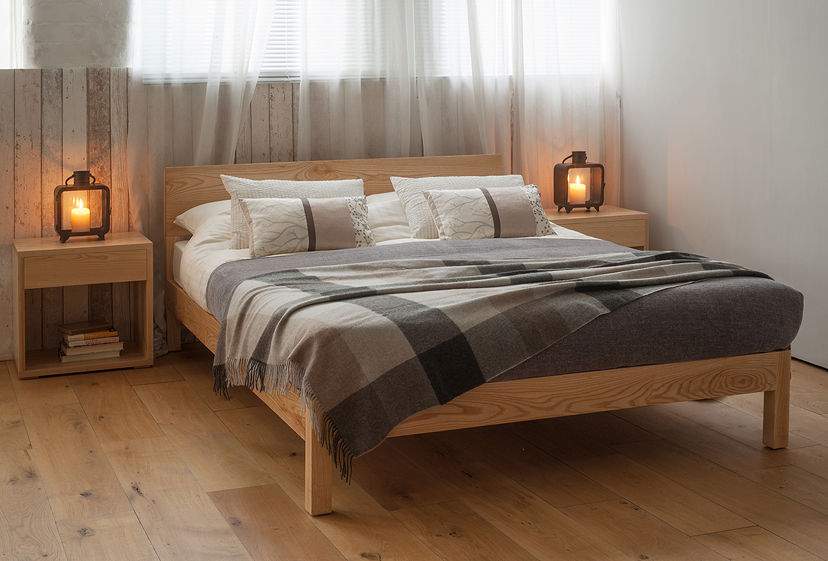 Sahara wooden Bed made from solid Ash is shown with Cube bedside tables in matching Ash wood.