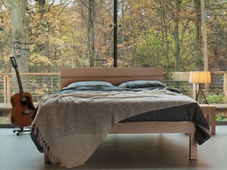 A striking bedroom with woodland view featuring our Tibet wooden bed