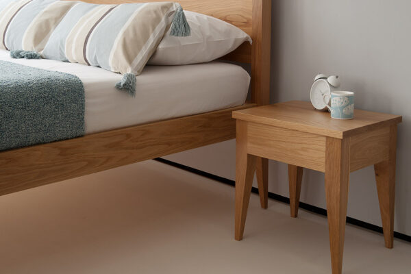 Cochin wooden bed with matching Cochin table here shown in Oak