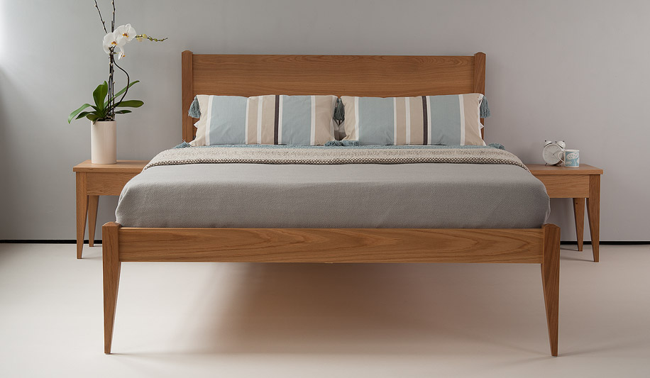 The Cochin solid wooden bed is shown here with matching bedside tables in Oak