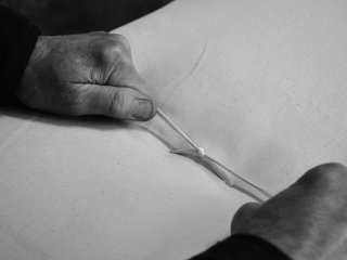 Hand tying the cotton threads in our futon mattress