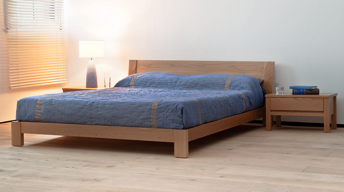 Java a contemporary low wooden bed in solid oak