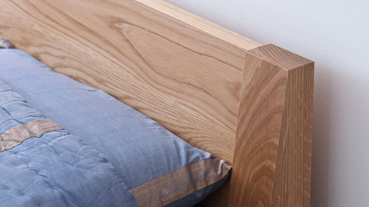 A closer look at the headboard of the Java low wooden bed in solid oak