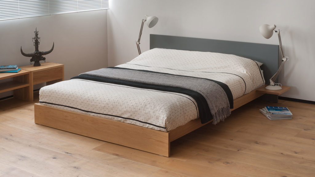 Koo is a low platform style bed with optional side tables and painted headboard