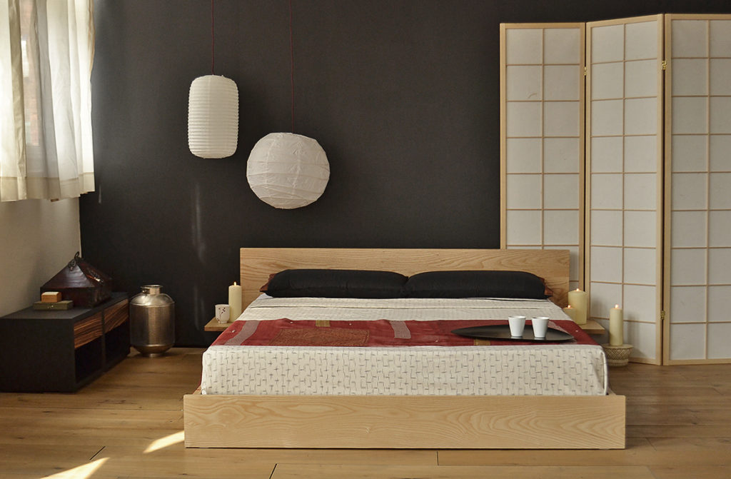 A Bedroom with an Oriental look featuring the low wooden Kulu bed made from solid Ash wood.