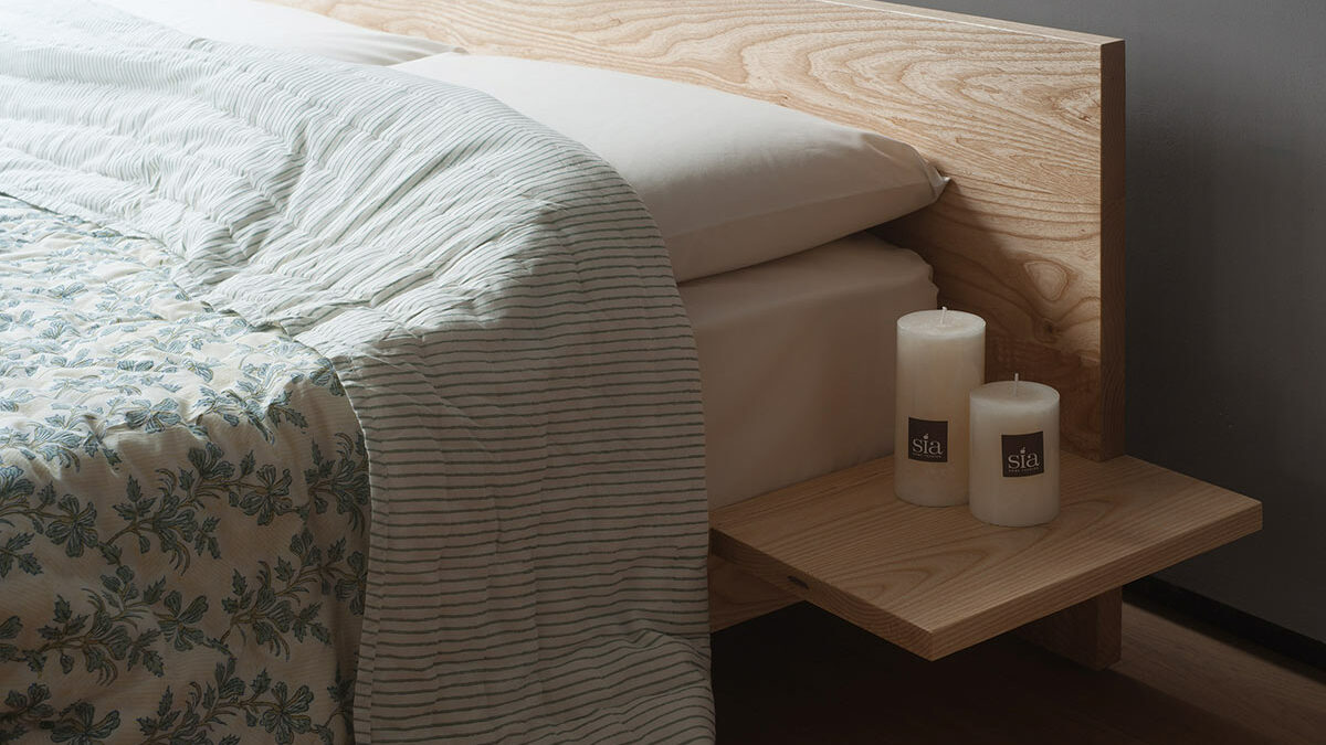 A closer view of the optional attached side tables on our hand made low Kulu wooden platform bed