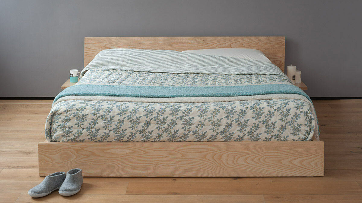 Our Kulu bed is a solid wooden platform style low bed with optional shelf tables attached