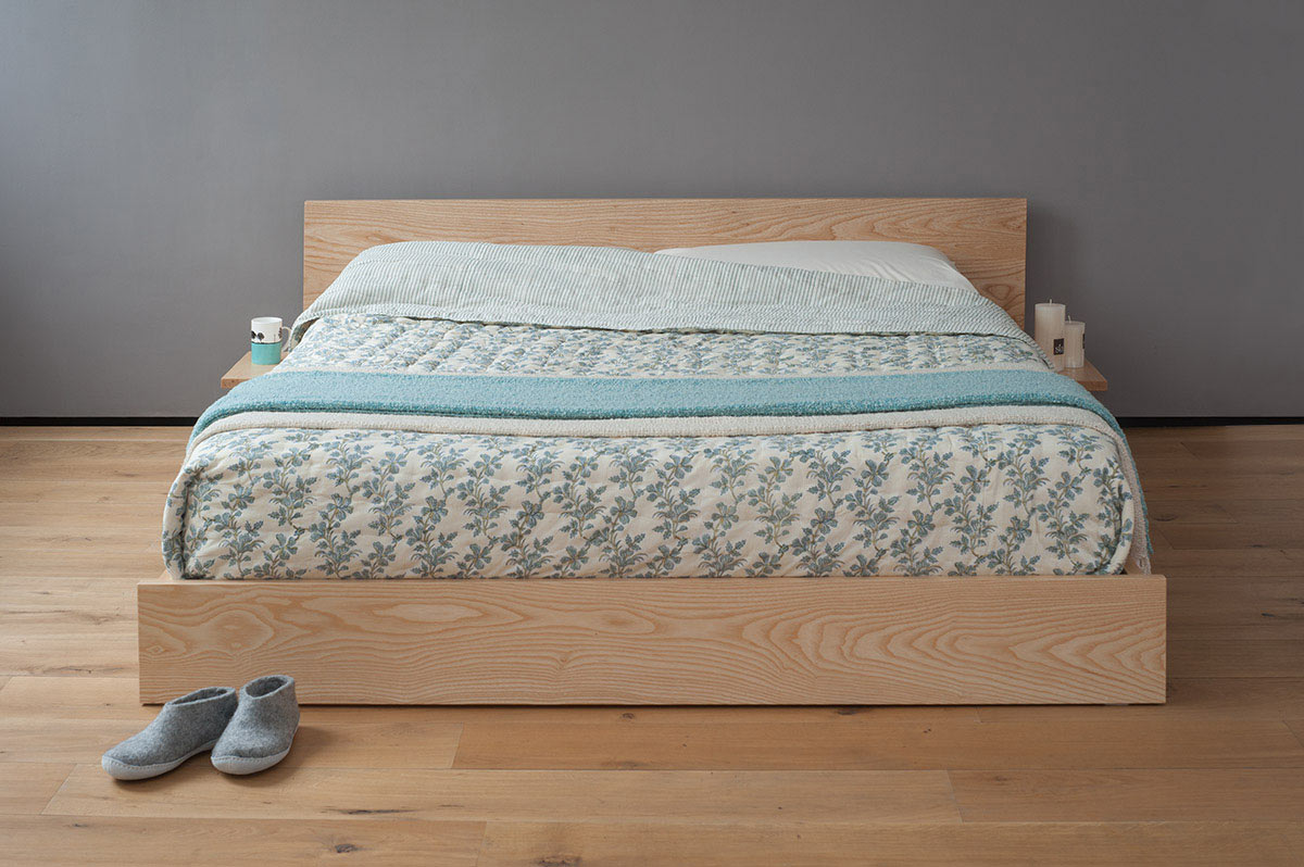 Our Kulu bed is a solid wooden platform style low bed with optional shelf tables attached