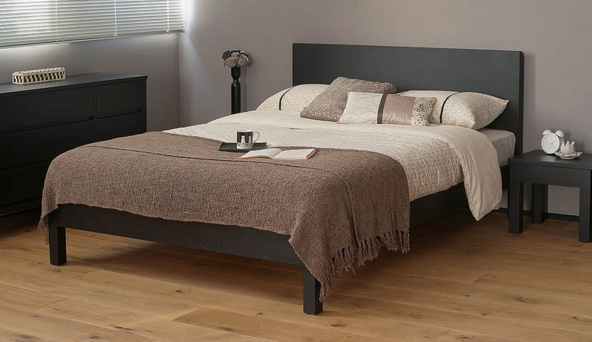 Black-painted Oak Malabar wooden bed for a striking monochrome bedroom