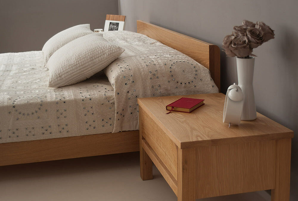 A side view our Nevada low wooden bed with bedside chest all in Oak