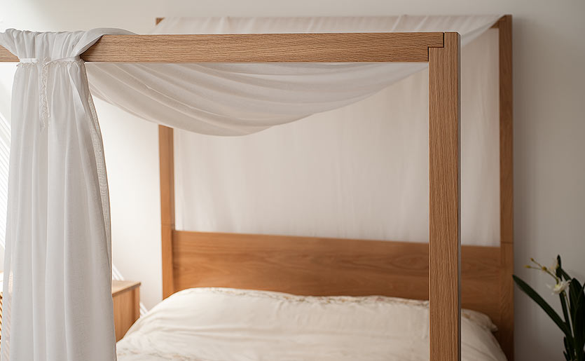 Our solid wood Oasis contemporary 4 poster bed shown with draped fabric canopy for a romantic look