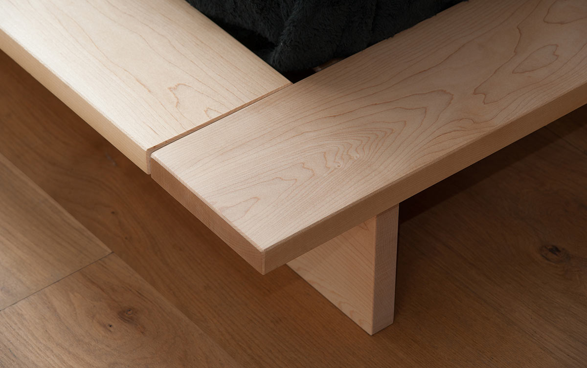 A closer view of the platform frame and leg of the Oregon solid wood low bed