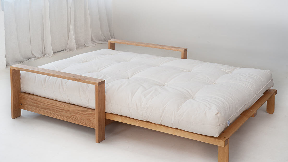 Panama sofa bed in Oak shown open as a bed with its futon mattress