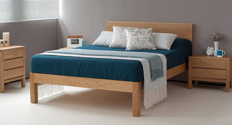 Tibet a chunky modern solid wooden bed shown here in Oak