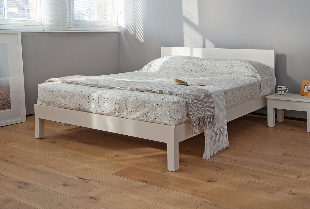 Sahara a contemporary low wooden bed here in a white lacquered finish