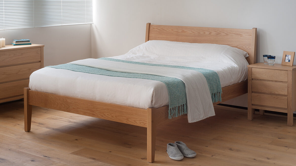 Our modern yet classic wooden Zanskar bed shown in Oak