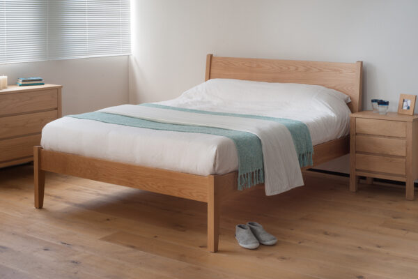 Our modern yet classic wooden Zanskar bed shown in Oak