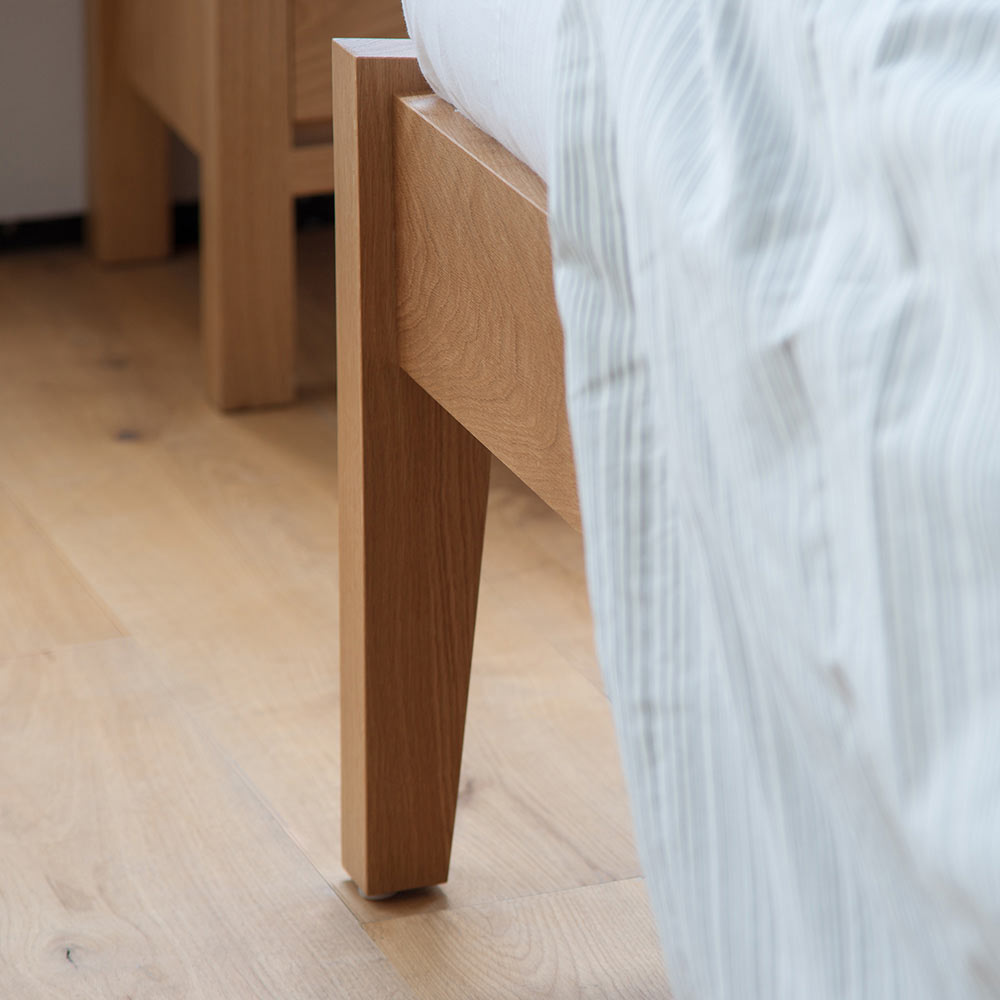 A close up of the leg joint of our Zanskar solid wooden bed