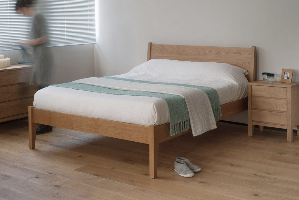 Contemporary bedroom with Zanskar solid wooden bed and Shaker drawers in Oak.