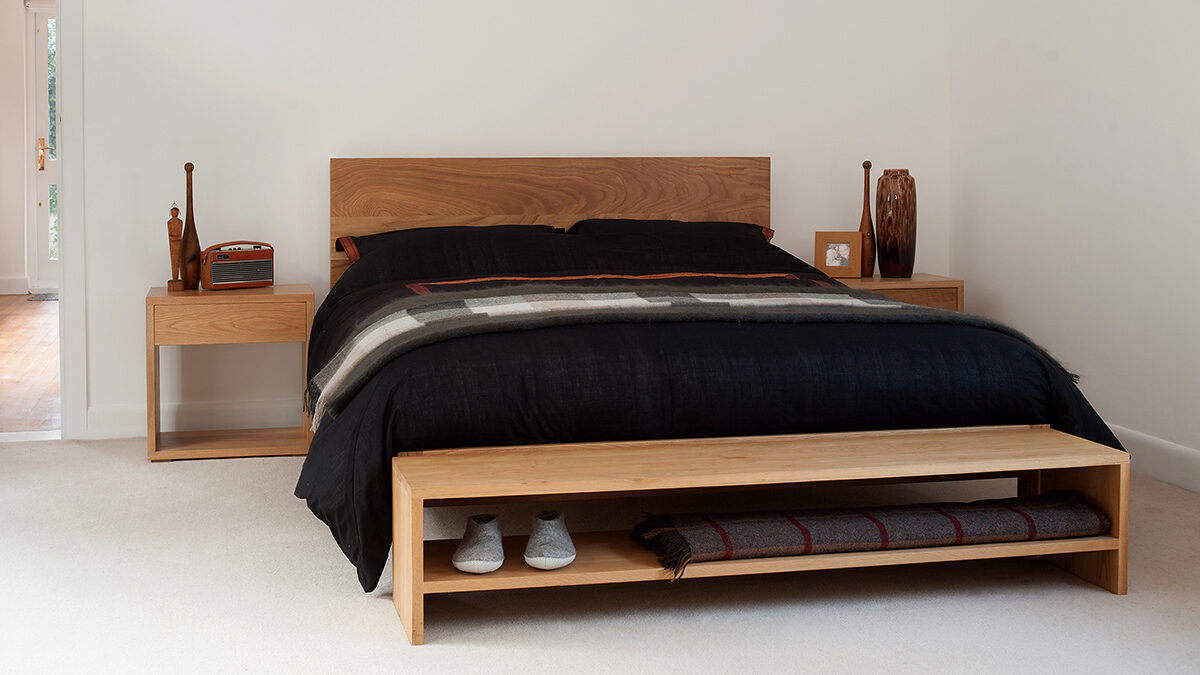 Scandinavian look solid oak modern malabar bed shown with Cube bedside table & oak storage bench