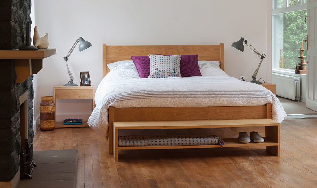 Contemporary bedroom with our wooden zanskar bed, Cube bedside tables, and storage bench, all in Oak.