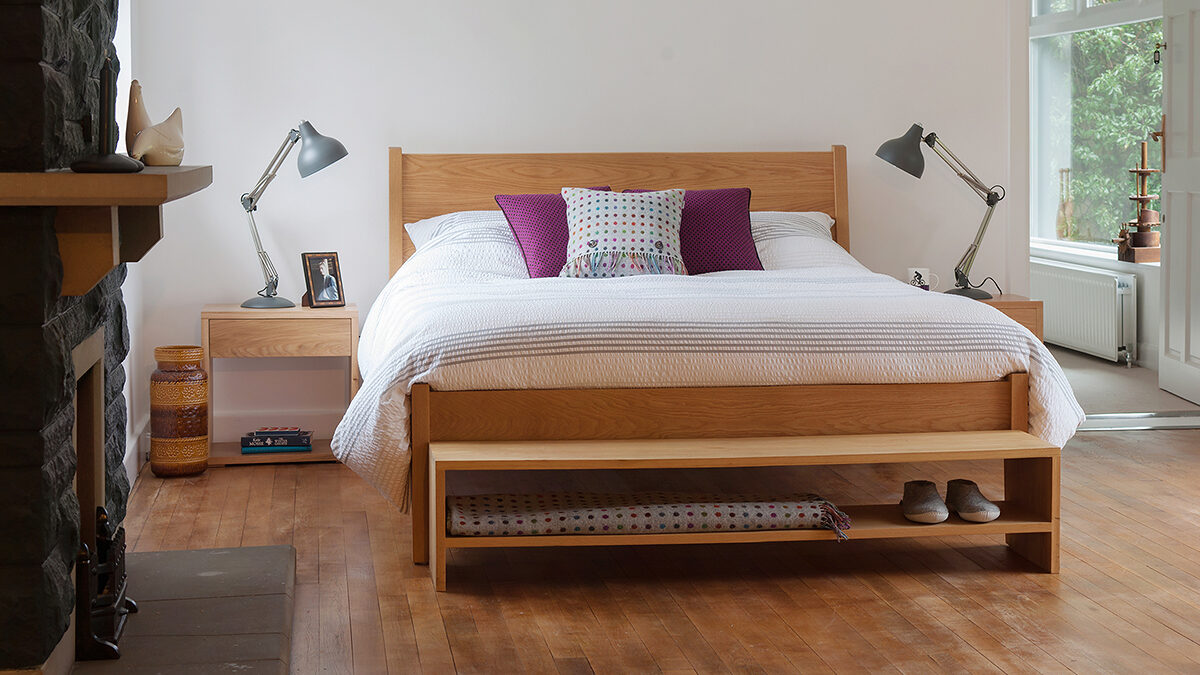 Contemporary bedroom with our wooden zanskar bed, Cube bedside tables, and storage bench, all in Oak.