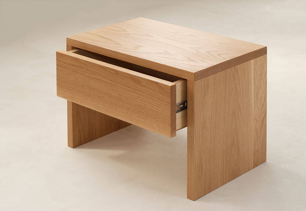 Hand made Kyoto bedside table in Oak showing the storage drawer open.