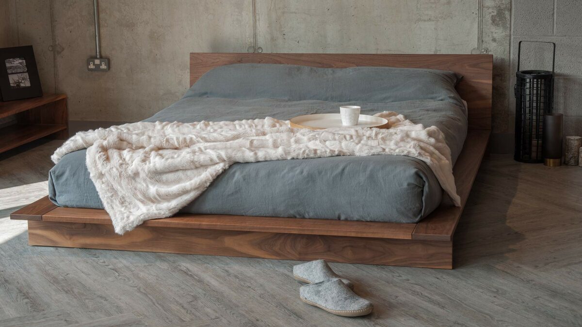 Low Japanese style solid wood bed The Oregon, here in walnut but available to order in a choice of wood