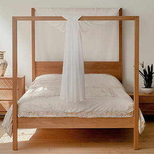 our Oasis four poster bed in Oak shown with fabric drapery for a romantic bedroom look