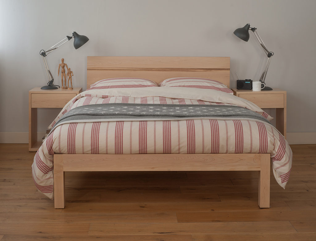 Modern solid wood Tibet bed with New England style bedding and Cube bedside tables.