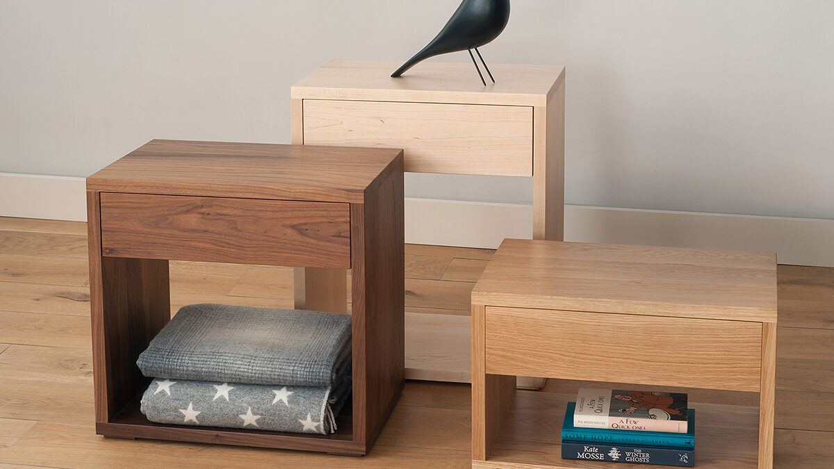 Cube bedside tables with storage drawer in 3 heights and made in a choice of wood.