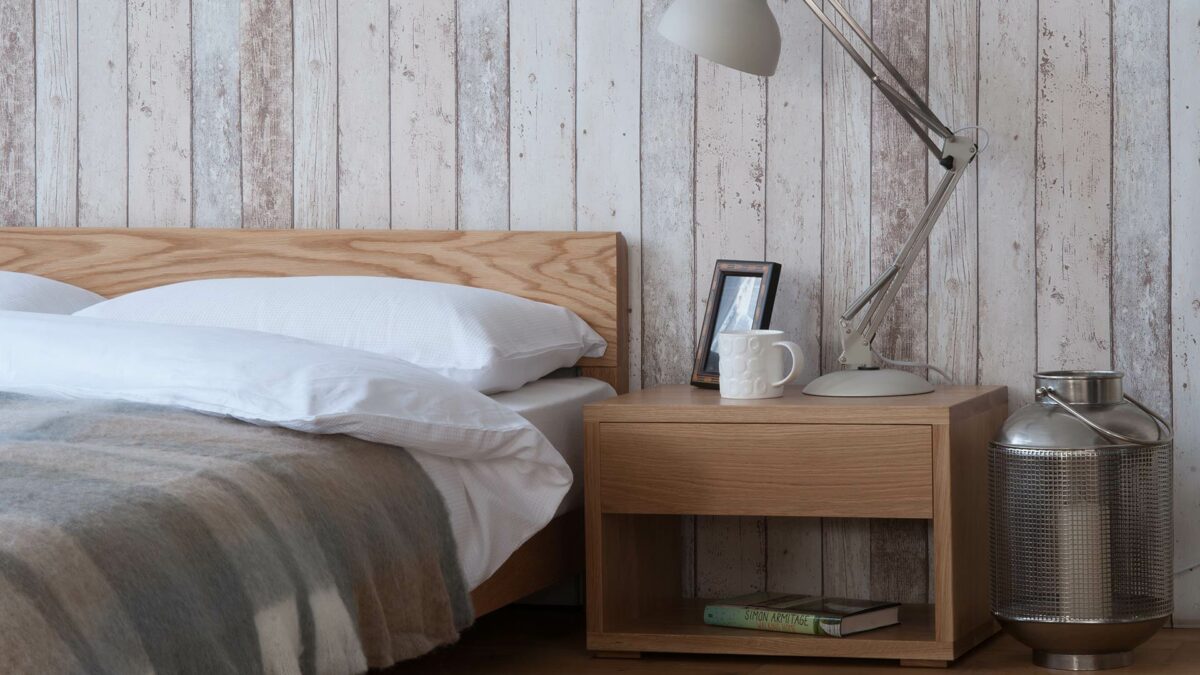 Oak Nevada low wooden bed shown with Cube bedside table also in Oak