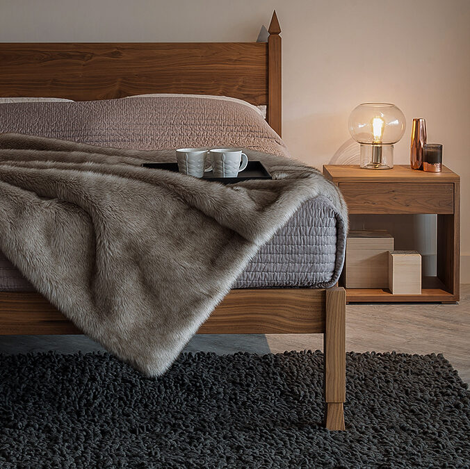 The Samarkand Indian inspired bed in Walnut shown with a Walnut Cube bedside table.