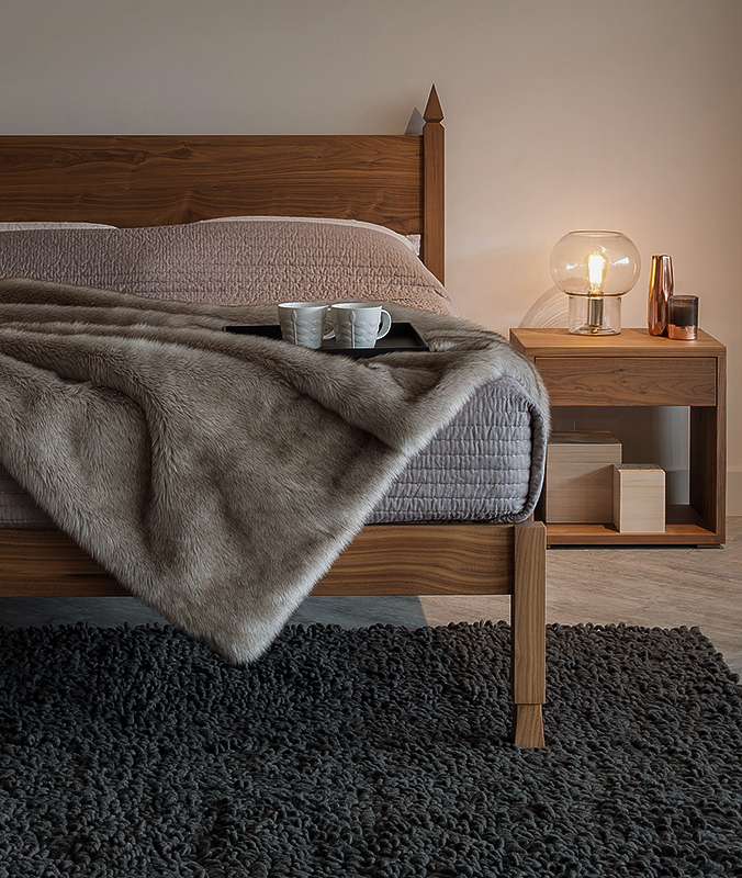 The Samarkand Indian inspired bed in Walnut shown with a Walnut Cube bedside table.