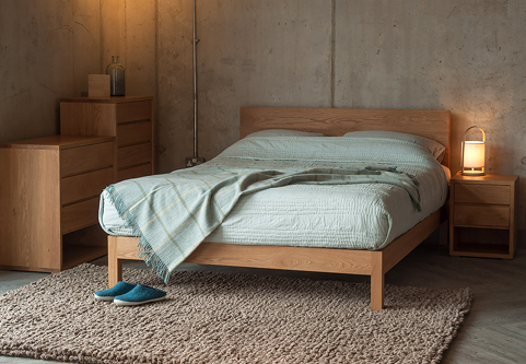 Contemporary Oak bedroom furniture solid wooden Malabar Bed with Cube collection chests of drawers.