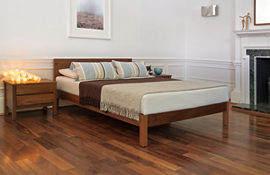 classic bedroom setting with walnut sahara low wooden bed and Shaker bedside drawers