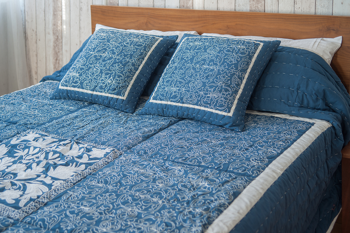 Embroidered quilt and cushions