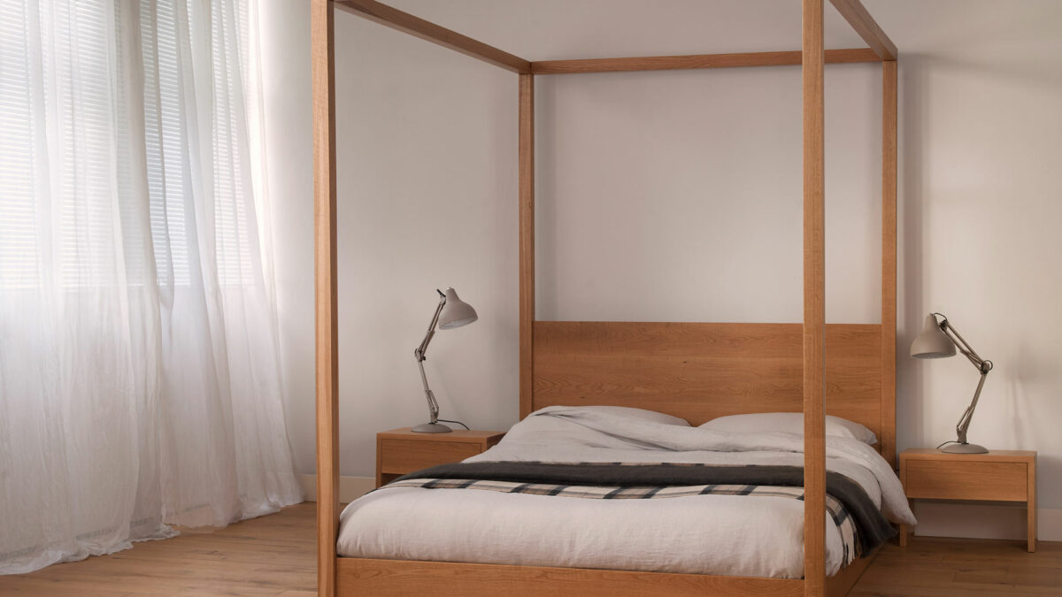 A low modern 4 poster bed, the Cube made by us in UK from solid wood and in a range of sizes.