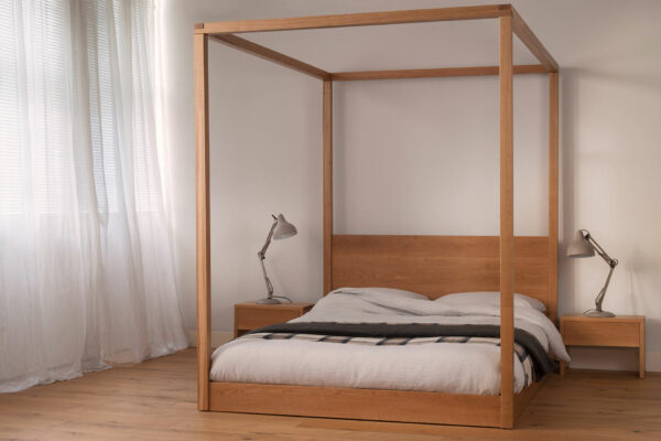 A low modern 4 poster bed, the Cube made by us in UK from solid wood and in a range of sizes.