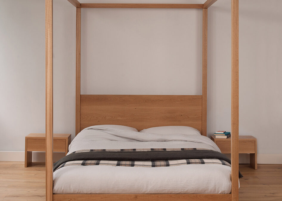 Cube - a low elegant and modern four poster bed. Hand made in Britain from solid wood.