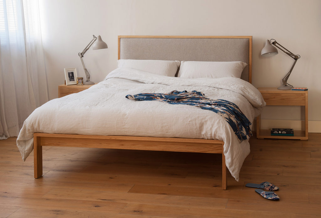 Shetland contemporary wooden bed with padded headboard, here in Oak with oak bedside tables