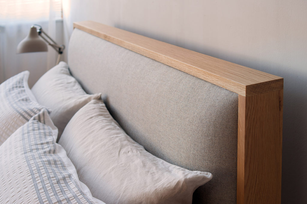 A closer view of the Shetland wooden bed padded headboard