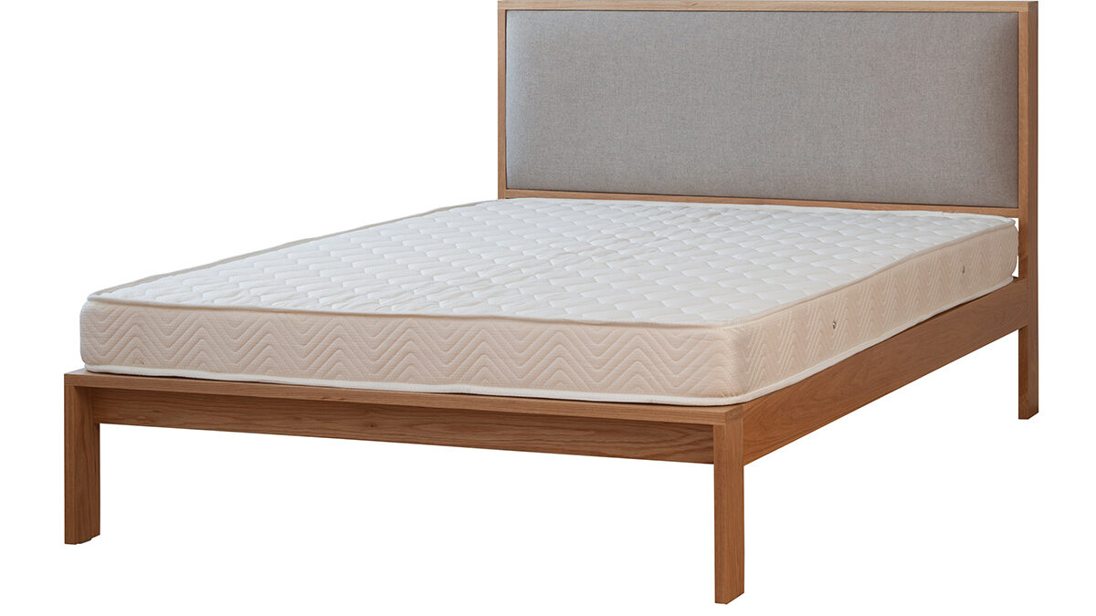 Shetland contemporary wooden bed with padded headboard shown without bedding